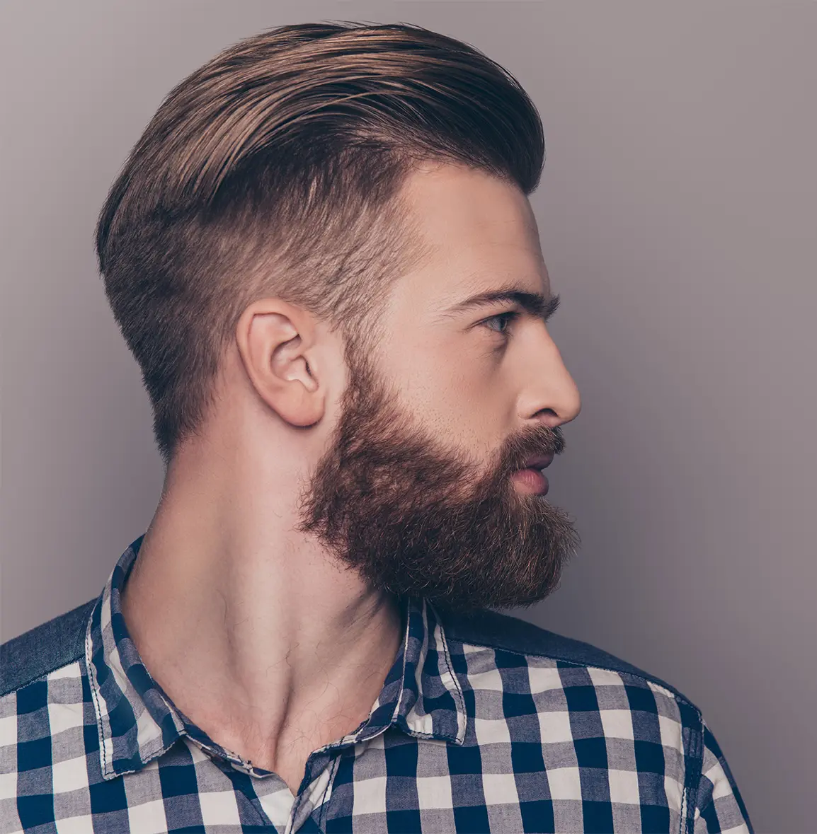 A man with a well-groomed beard after a beard camouflage procedure