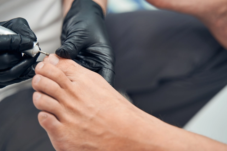 Beautician doing hardware pedicure for male